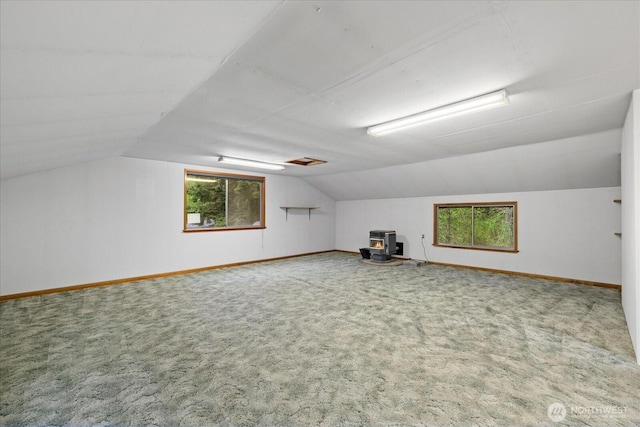 bonus room featuring baseboards, vaulted ceiling, carpet flooring, and a wealth of natural light