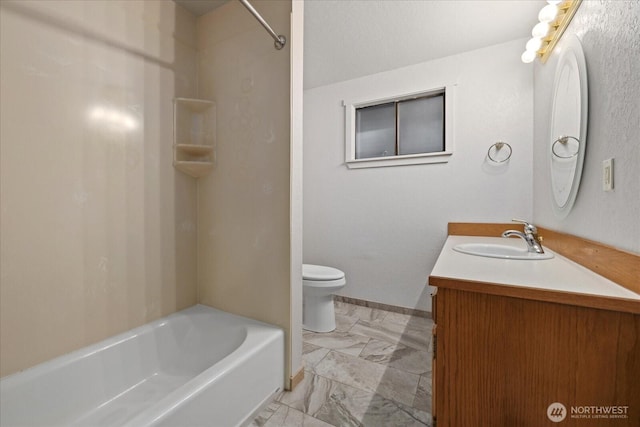 bathroom with vanity, baseboards, shower / bath combination, and toilet