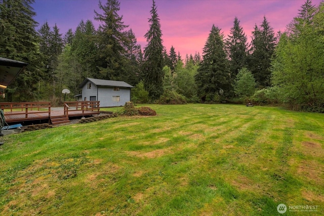 yard at dusk with a wooden deck