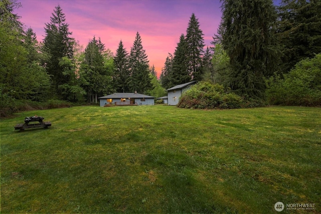 view of yard with a view of trees