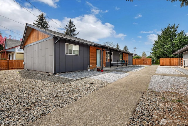 view of front of property featuring board and batten siding and fence
