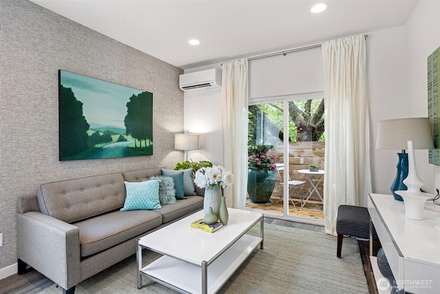 living room featuring an AC wall unit, recessed lighting, and wood finished floors