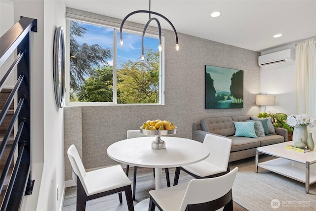 dining area featuring an AC wall unit, recessed lighting, and wood finished floors