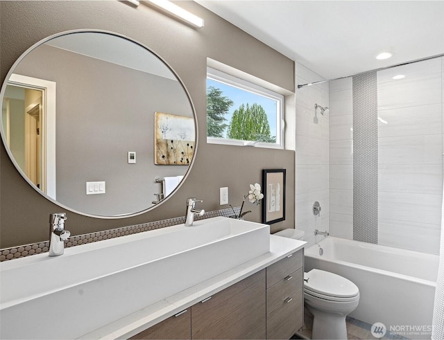bathroom featuring toilet, recessed lighting, washtub / shower combination, and vanity