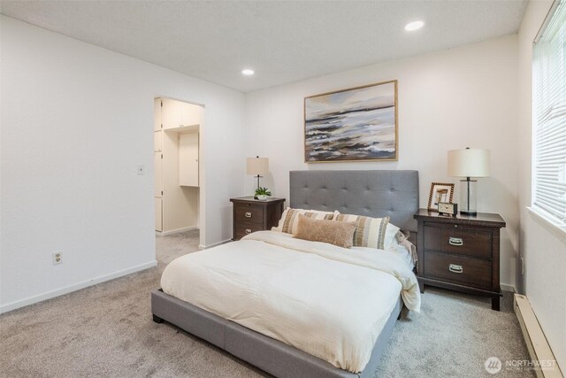 12621 NE 130th Way # D106, Kirkland, WA 98034 - bedroom featuring carpet floors, a baseboard radiator, baseboards, and multiple windows