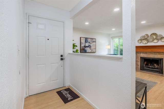 12621 NE 130th Way # D106, Kirkland, WA 98034 - entryway featuring recessed lighting, baseboards, wood finished floors, and a tile fireplace