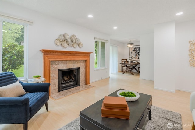 12621 NE 130th Way # D106, Kirkland, WA 98034 - living room featuring recessed lighting, a tiled fireplace, and light wood-style floors