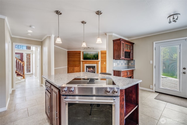 kitchen featuring stainless steel range with electric cooktop, ornamental molding, baseboards, light stone countertops, and hanging light fixtures