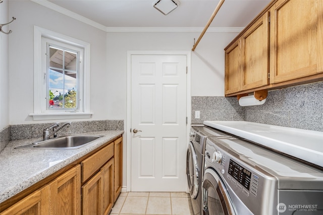 clothes washing area with independent washer and dryer, cabinet space, light tile patterned floors, and crown molding