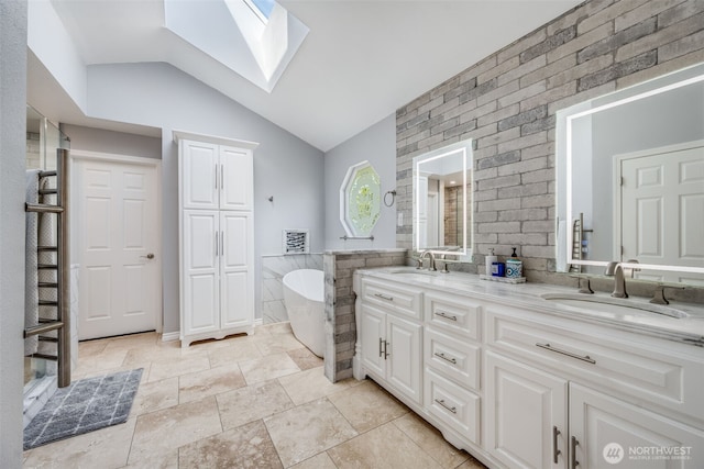full bathroom with a skylight, vaulted ceiling, a soaking tub, double vanity, and tile walls