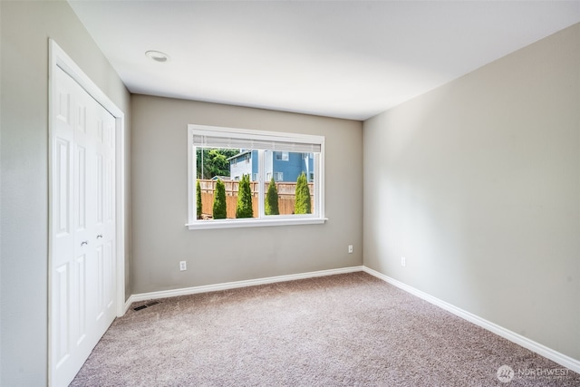 unfurnished bedroom featuring carpet flooring, a closet, and baseboards