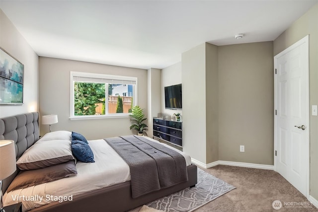 bedroom featuring carpet flooring and baseboards