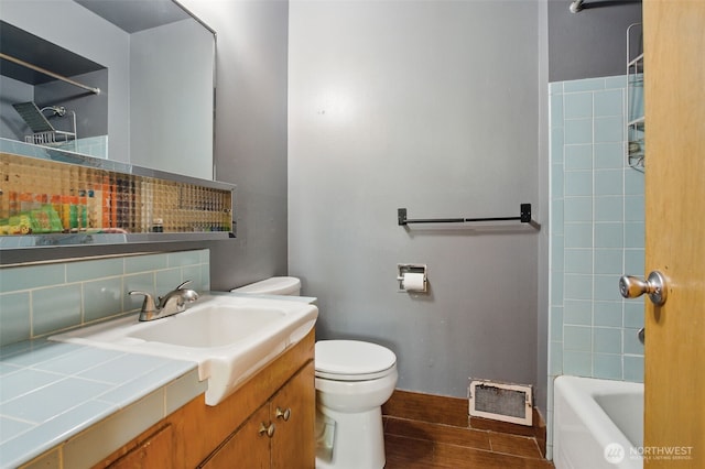 full bathroom with backsplash, visible vents, wood finished floors, vanity, and toilet