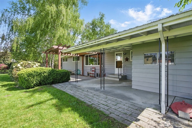 back of property with a lawn, a patio, and a pergola