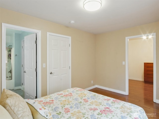 bedroom featuring baseboards and dark wood-style floors