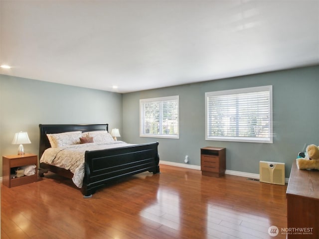bedroom featuring baseboards, recessed lighting, and wood finished floors
