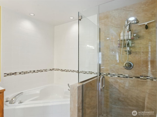 full bathroom featuring vanity, a shower stall, and a bath
