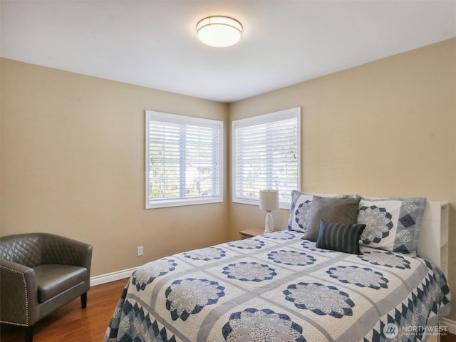bedroom featuring baseboards and wood finished floors