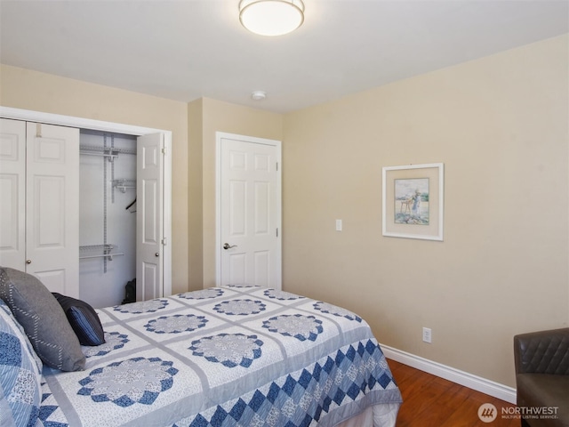 bedroom with a closet, baseboards, and dark wood-type flooring