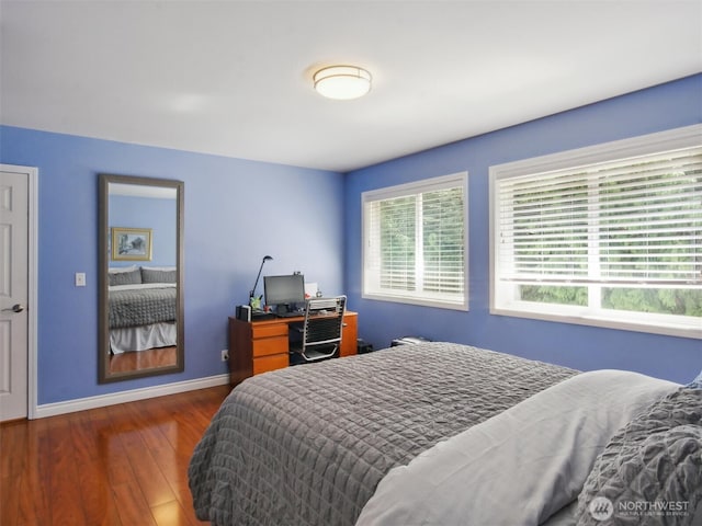 bedroom with baseboards and wood finished floors