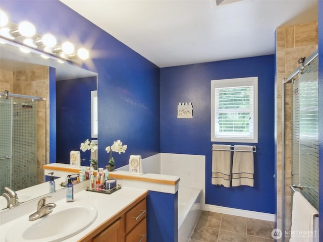 full bath with a bath, tile patterned flooring, a shower stall, vanity, and baseboards