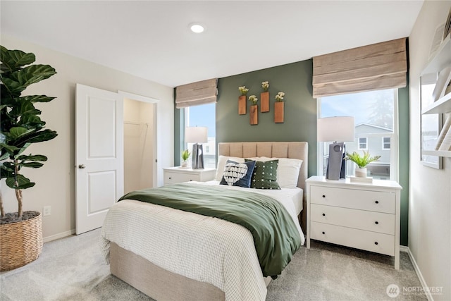 bedroom featuring baseboards, light carpet, and recessed lighting