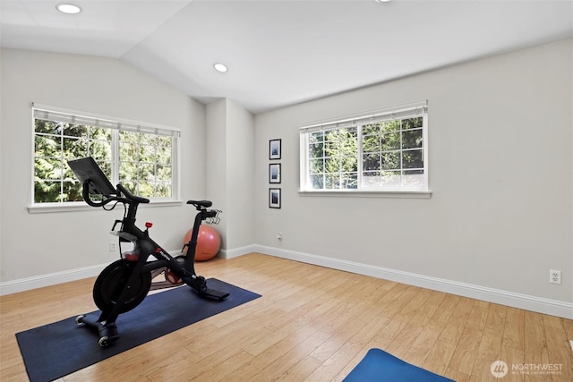 exercise room with baseboards, recessed lighting, wood finished floors, and lofted ceiling