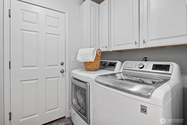 laundry area featuring cabinet space and washing machine and clothes dryer