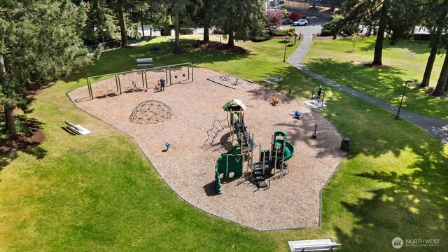 surrounding community with a yard and playground community