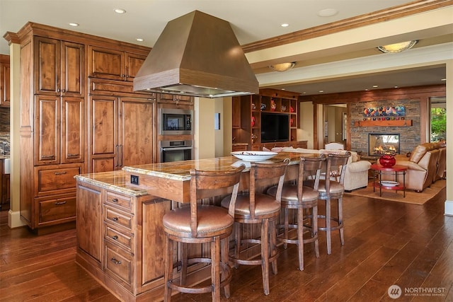 5844 Mutiny Bay Rd, Freeland, WA 98249 - kitchen featuring brown cabinetry, a kitchen island, island exhaust hood, appliances with stainless steel finishes, and dark wood-type flooring