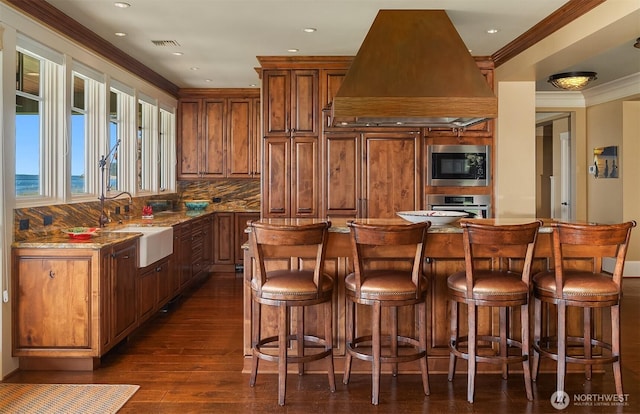 5844 Mutiny Bay Rd, Freeland, WA 98249 - kitchen featuring light stone countertops, custom range hood, a sink, dark wood-style floors, and stainless steel appliances