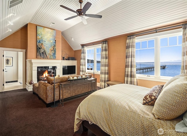 5844 Mutiny Bay Rd, Freeland, WA 98249 - carpeted bedroom with a ceiling fan, visible vents, vaulted ceiling, wooden ceiling, and a glass covered fireplace