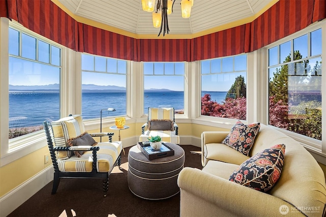 5844 Mutiny Bay Rd, Freeland, WA 98249 - sunroom featuring a water view, baseboards, a notable chandelier, and wallpapered walls