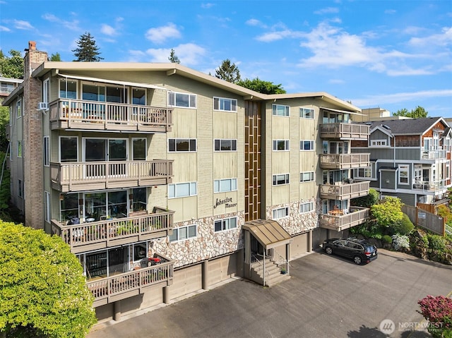 view of apartment building / complex featuring a garage