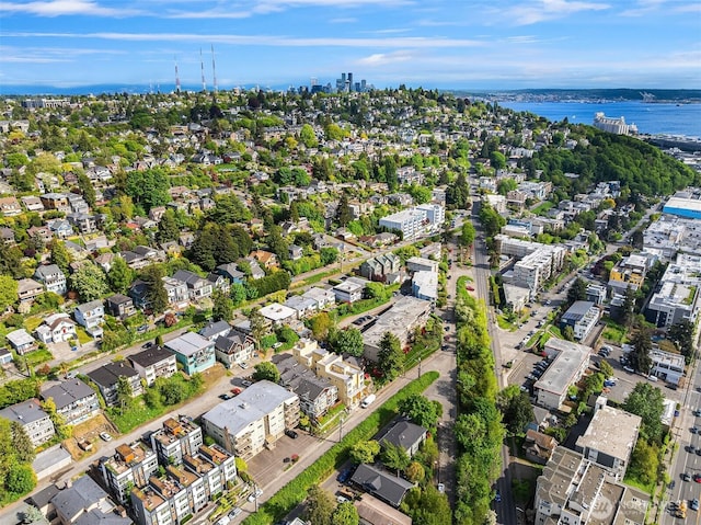 aerial view of property and surrounding area featuring a large body of water