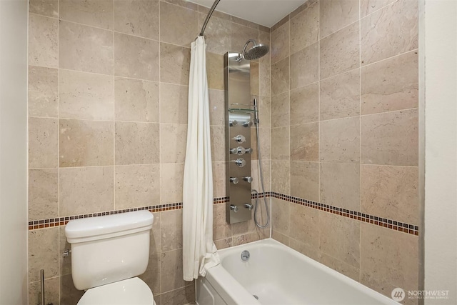 full bathroom with tile walls, shower / bath combo with shower curtain, and toilet