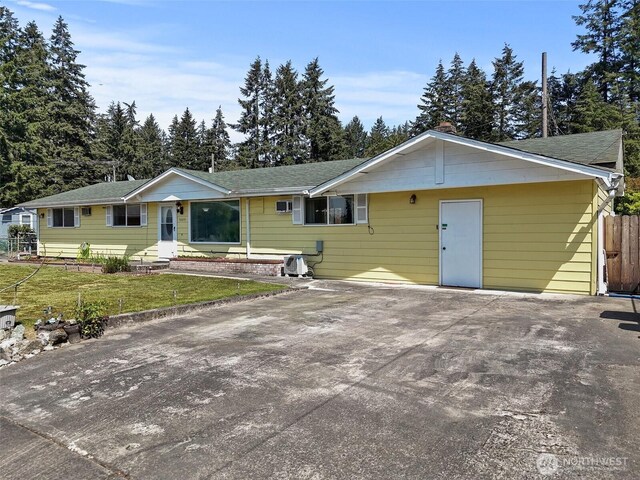 ranch-style home with fence and a front yard
