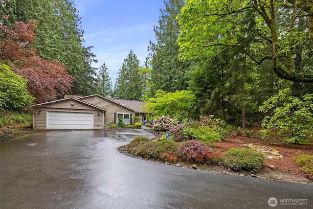 ranch-style home with a garage and driveway