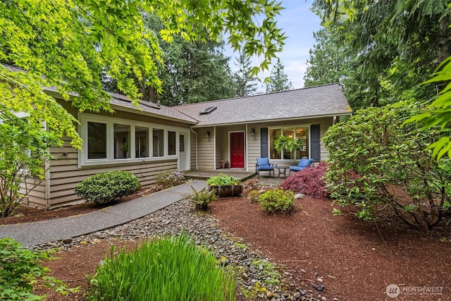 ranch-style house featuring roof with shingles