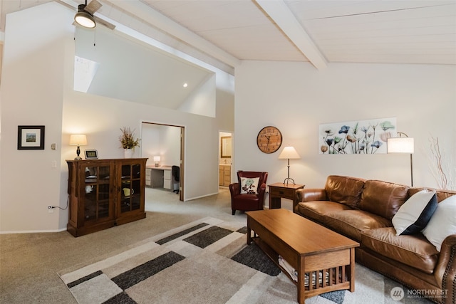 living area with a ceiling fan, light colored carpet, lofted ceiling with beams, and baseboards