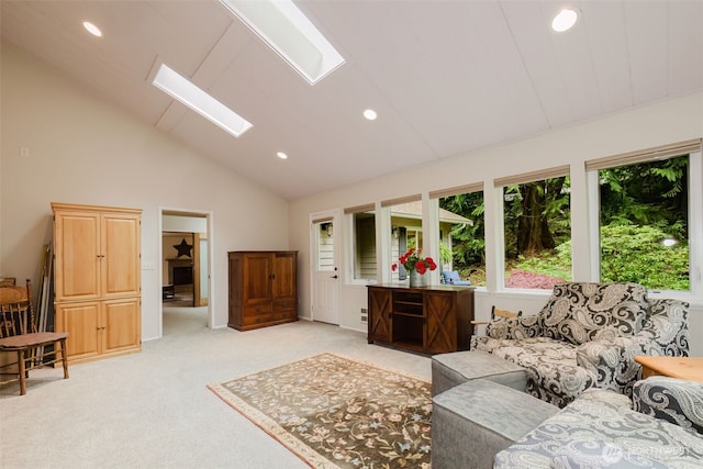 living room featuring a skylight, high vaulted ceiling, light carpet, and recessed lighting