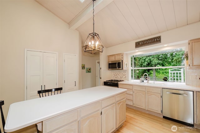 kitchen with appliances with stainless steel finishes, tasteful backsplash, a sink, light countertops, and lofted ceiling with beams