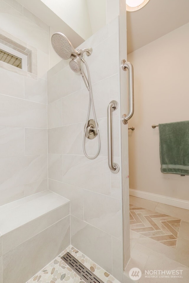 full bathroom featuring tile patterned floors and a tile shower