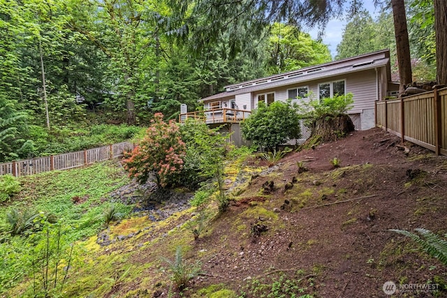 view of yard featuring a fenced backyard and a deck