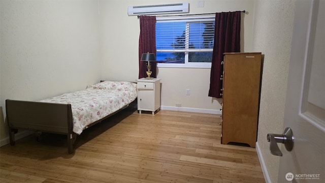942 S 293rd St, Federal Way, WA 98003 - bedroom featuring an AC wall unit, baseboards, and wood finished floors