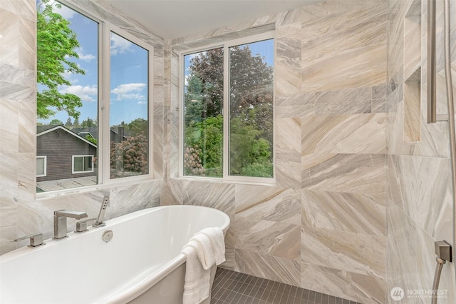 4019B 4th Ave NE, Seattle, WA 98105 - bathroom with tile patterned flooring, a freestanding tub, and tile walls