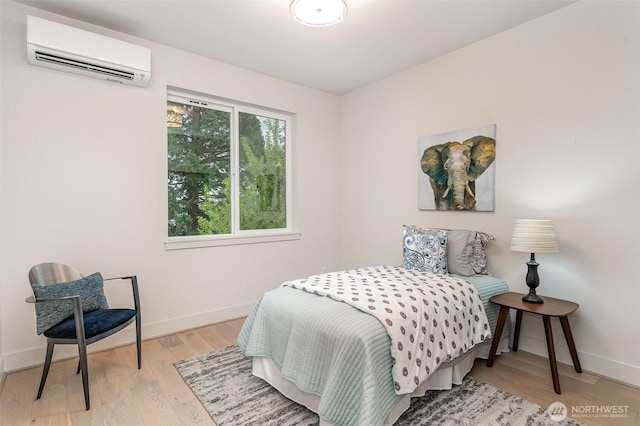 4019B 4th Ave NE, Seattle, WA 98105 - bedroom with an AC wall unit, baseboards, and wood finished floors