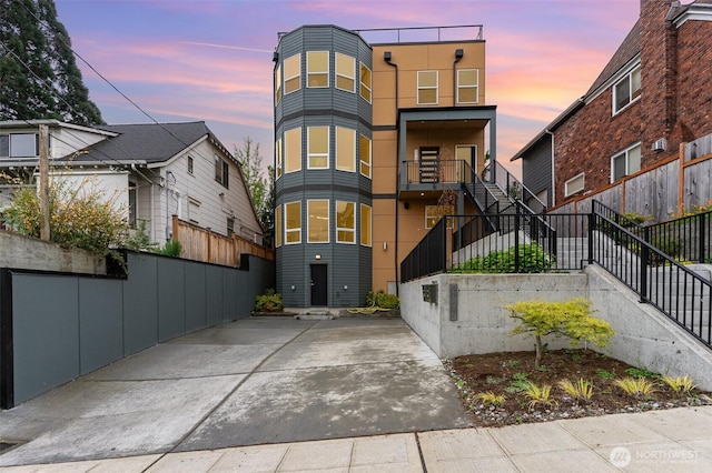 4019B 4th Ave NE, Seattle, WA 98105 - view of front of house with stucco siding, fence, and stairway
