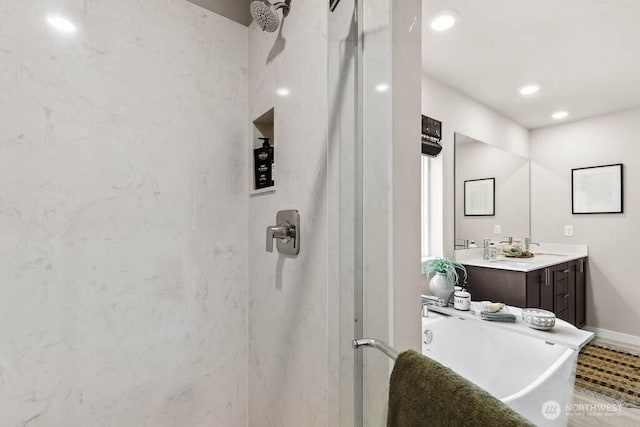 full bathroom with vanity, baseboards, recessed lighting, a freestanding bath, and a stall shower