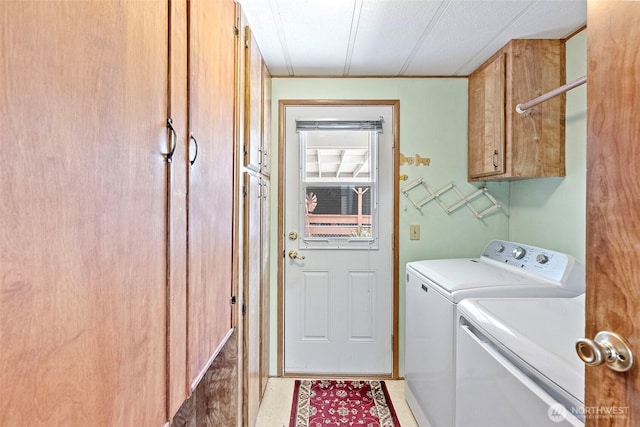 clothes washing area with cabinet space and washing machine and clothes dryer